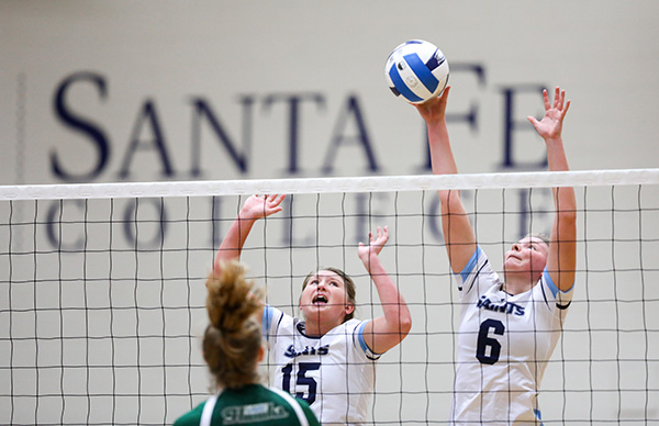 Meagan Irish and Maggie Mathews jump to block a shot. The Santa Fe College Saints defeated Lake Sumter State College in three sets on Wednesday, August 23, 2017 in Gainesville, Fla. (photo by Matt Stamey/Santa Fe College) 