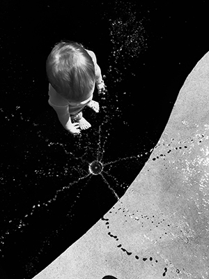 Matthew Shaffer artwork entitled Maisie - overhead picture of a child dropping a rock into a dark abyss