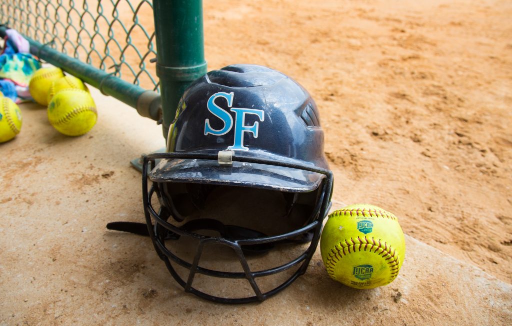 Saints softball batting helmet and softball.