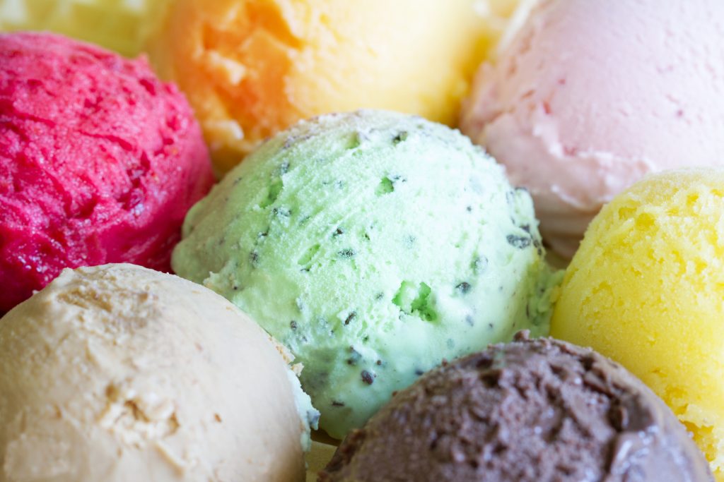 Colorful scoops of ice cream background concept closeup