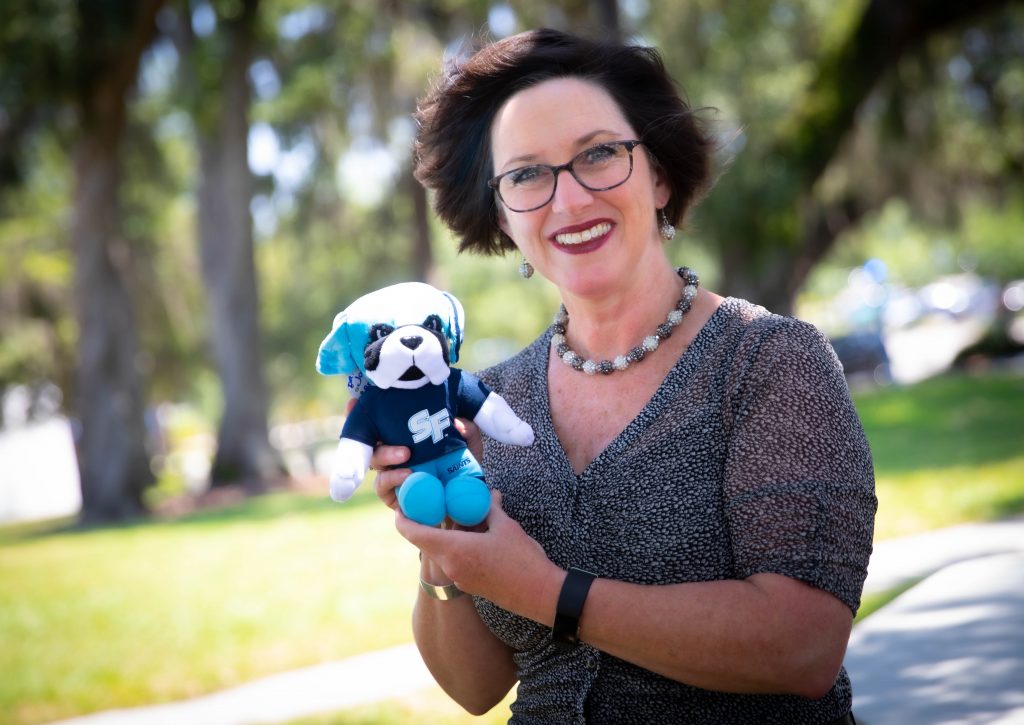 The May 2019 Santa Fe College Brand Ambassador Jodi Long with a plush Caesar doll.