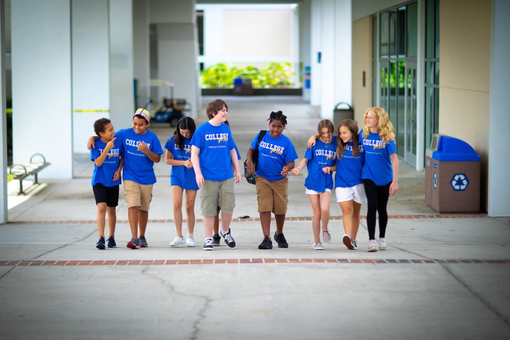 A group of Santa Fe College- College for Kids walk under a breezeway on the NW Campus.