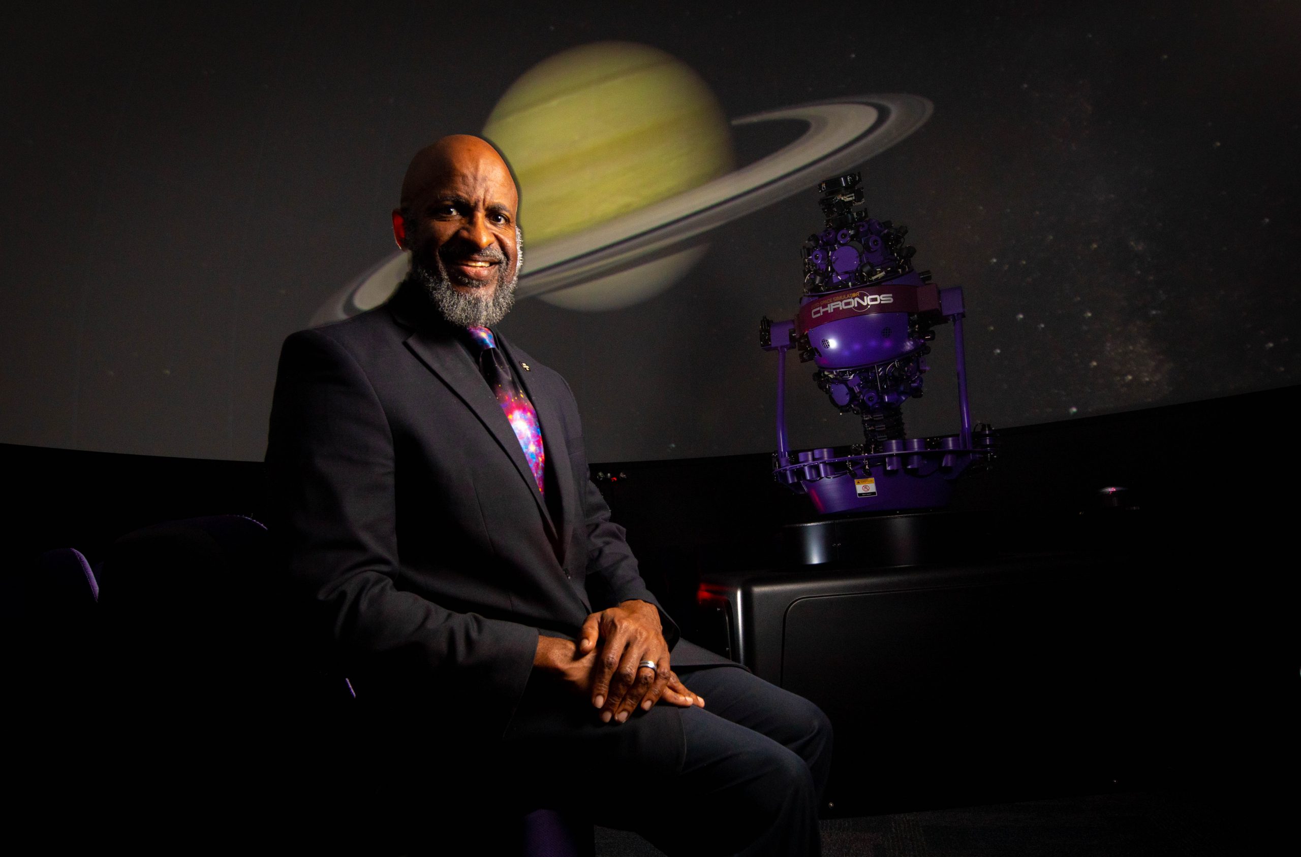 Santa Fe College Kika Silva Pla Planetarium director James C. Albury sits in front of the Chronos on Feb. 21, 2023 in Gainesville.