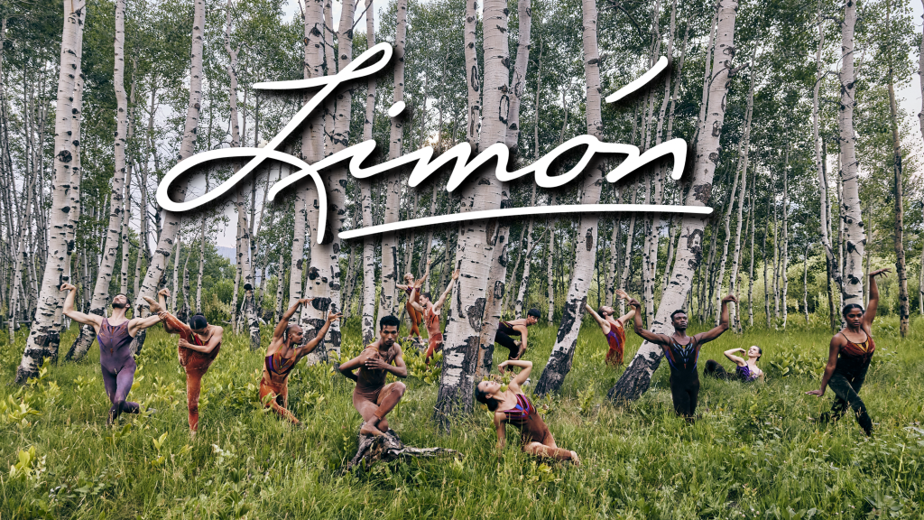 12 dancers posing in a forest.
