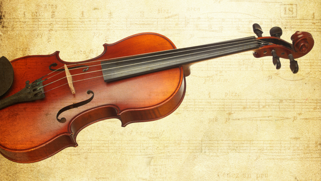 A violin in front of a sheet music background.