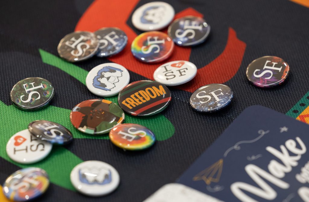 a collection of buttons promoting freedom and Santa Fe College