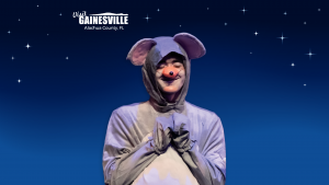 an actor dressed as a mouse smiling