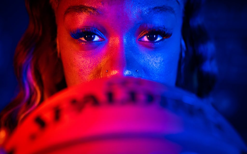 Santa Fe College Saints Women’s Basketball player Khaleah Douglas with a basketball in front of her face below the nose