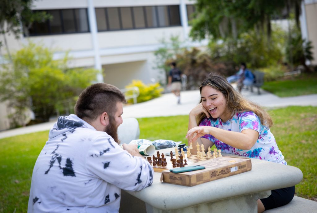 Santa Fe College students play a game in the Oak Grove.