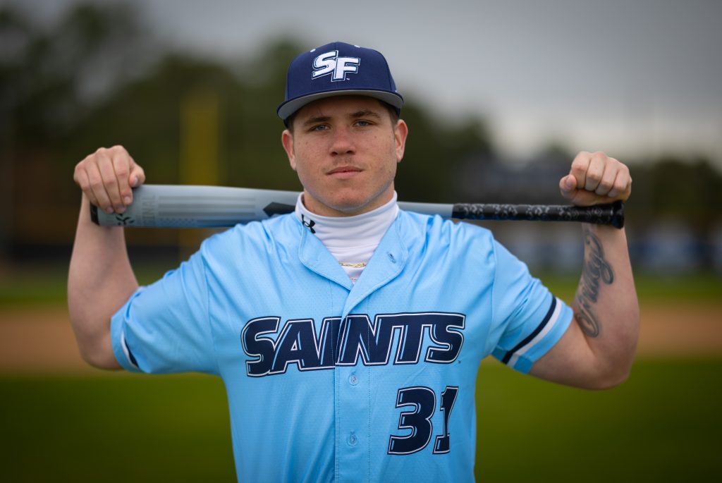 Santa Fe College Saints Baseball player Cory Filley stands with his baseball bat across his shoulders.