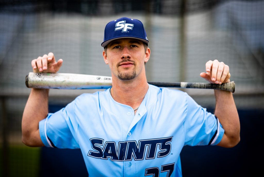 Santa Fe College Saints Baseball player Landon Rogers holds a baseball bat across his shoulders