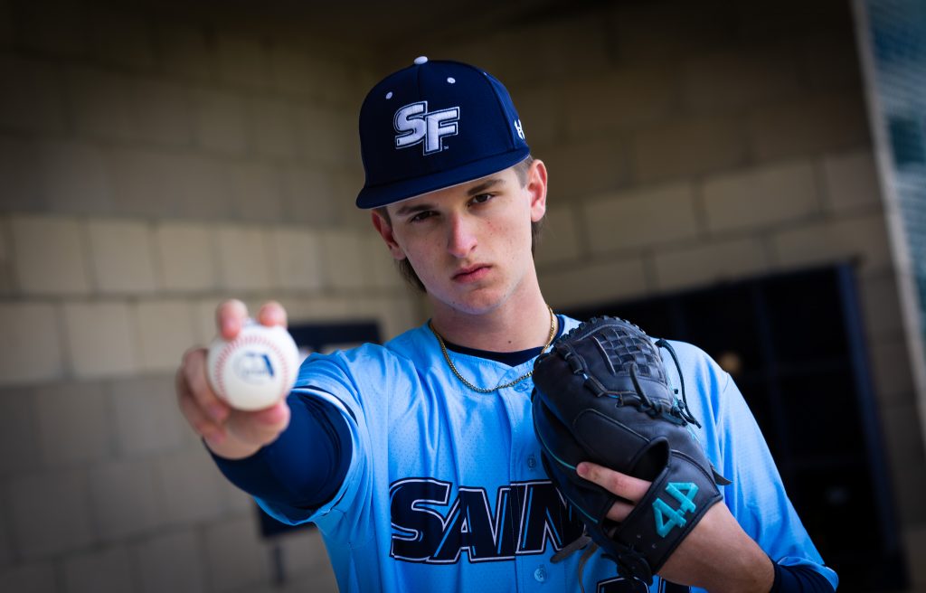 Santa Fe College Saints Baseball player Nick Staszak holds a baseball up.