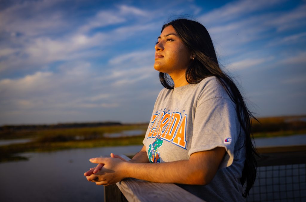 Santa Fe College graduate and University of Florida student Rafa Hossain looks in the distance amid a nature setting.