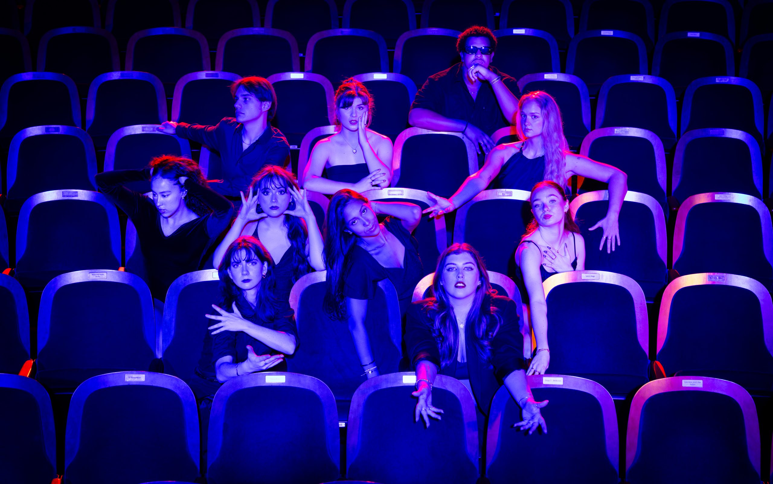 Individuals sitting in a theater.