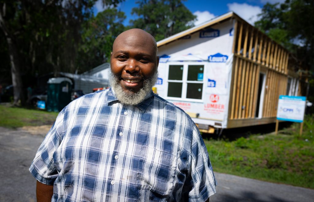 Habitat for Humanity home recipient Toikeith Reynolds seen as the house is moved into position.