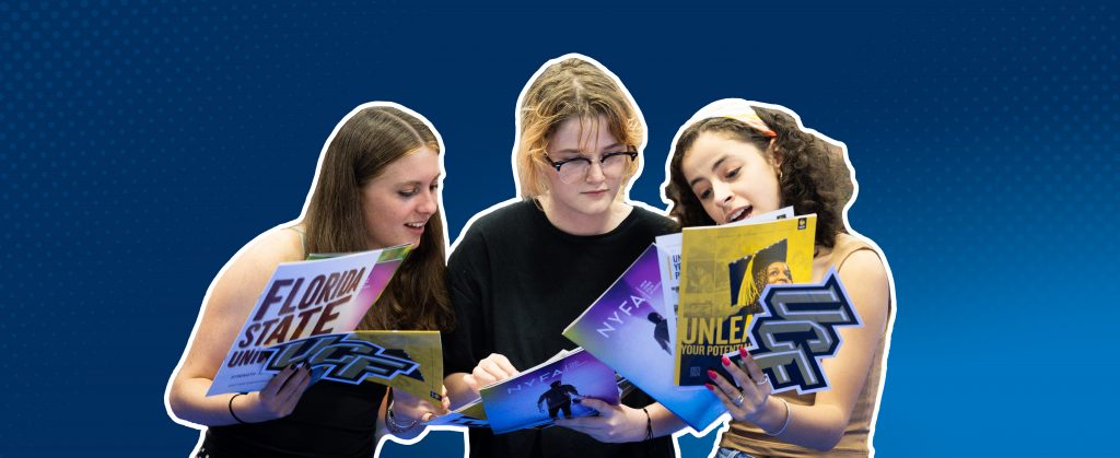 Three people looking at college brochures.