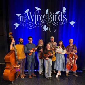 A group of people with musical instruments posing for a photo.